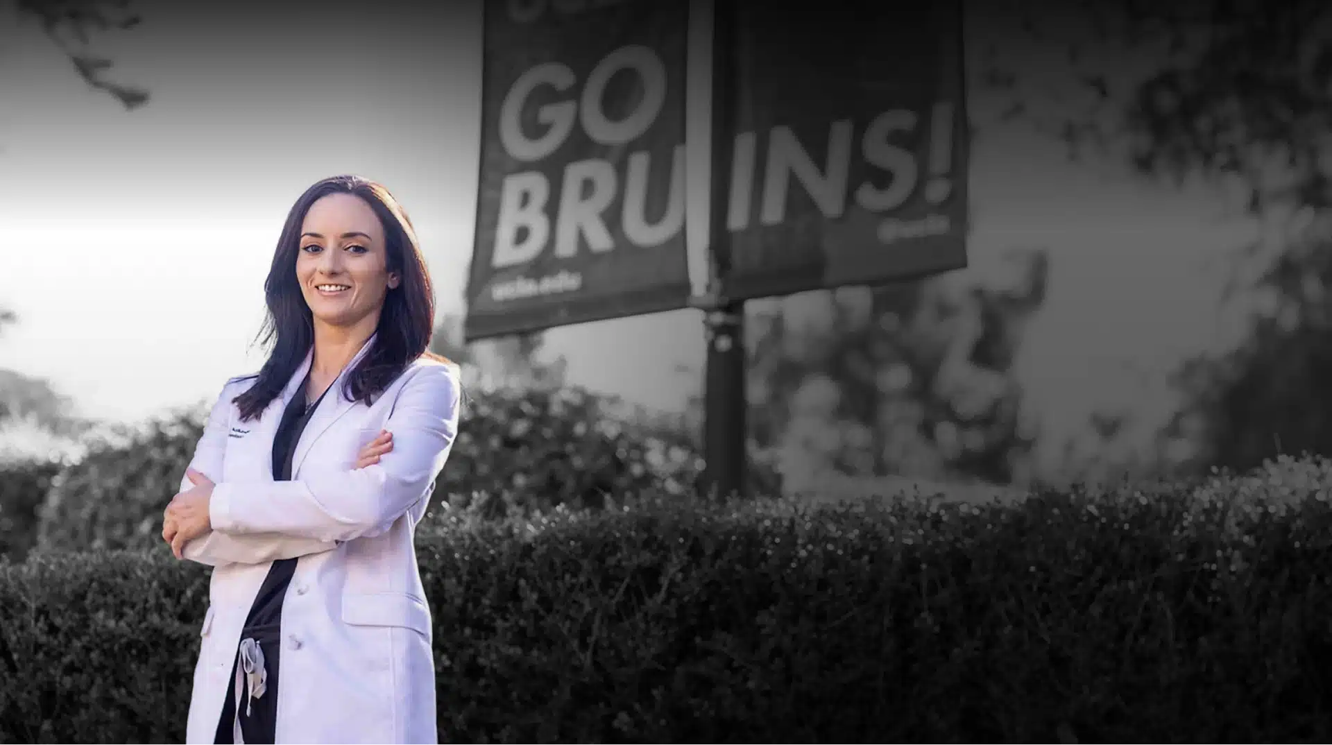 Female dentist in white coat smiling at Burbank dental practice location.