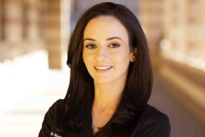 Professional female dentist smiling at Burbank dental practice.