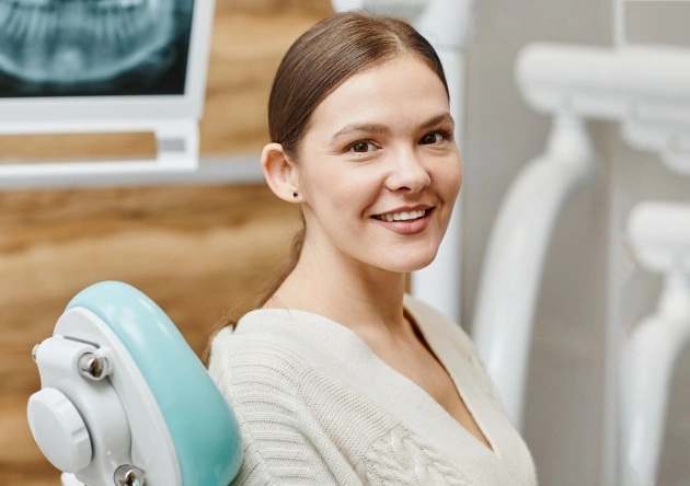 Girl smiling while sitting in a dentist chair at a Burbank dental office 