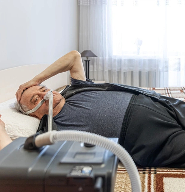 Senior man receiving sleep apnea treatment at a dental office