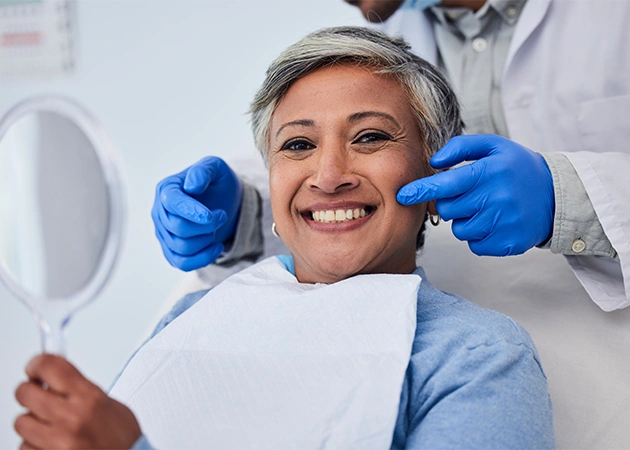 Senior smiling after holistic treatment in the chair