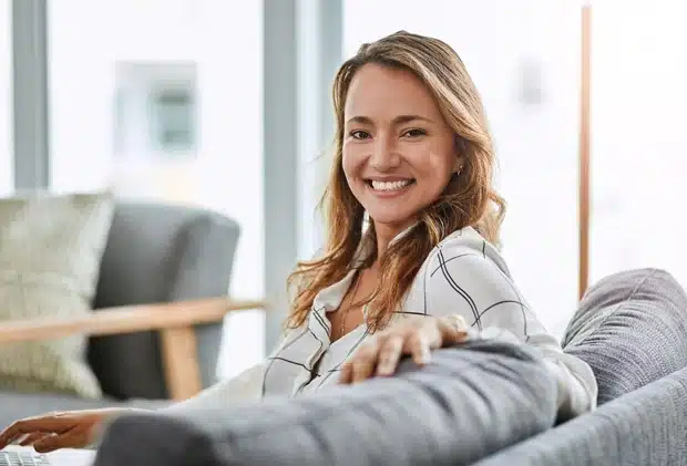 Smiling girl sitting and waiting in dental office waiting area